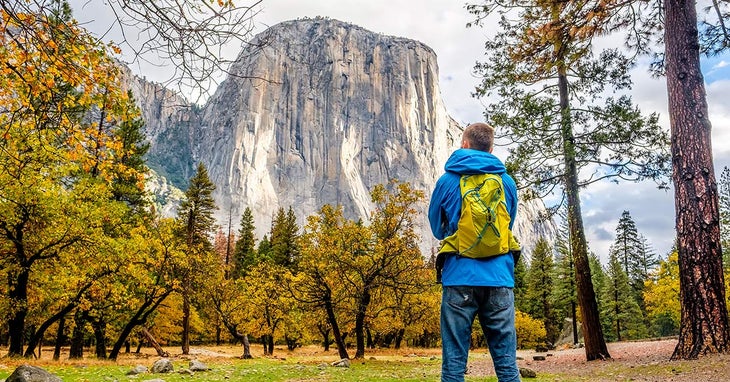 YO-ElCapitan-hiker-autumn_DP_FB1200 A hiker gazes at El Capitan in Yosemite in autumn