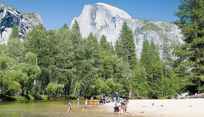Merced-kids-Housekeeping-Camp_Ordelheide_680 Kids swimming in the Merced River at the Housekeeping Camp Beach with the Half Dome in the Background. Photo by Grant Ordelheide