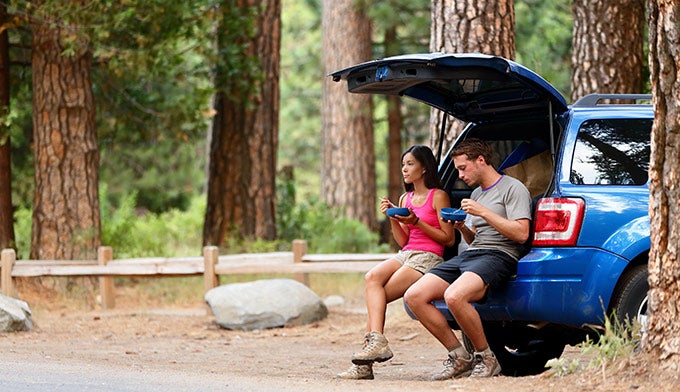 Eating-food-car-forest_DP_680 Eating food out of the back of a car in a forest