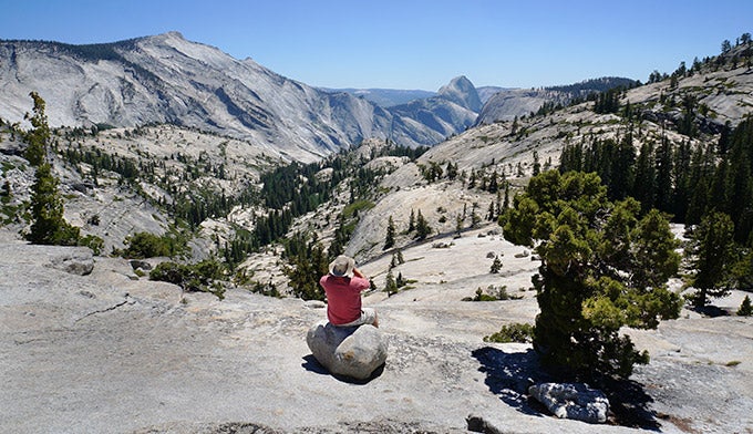 YT-Olmsted-Overlook6_Gloria_680 Using binoculars at Olmsted Point to watch hikers ascend Half Dome in Yosemite. Photo by Gloria Wadzinski