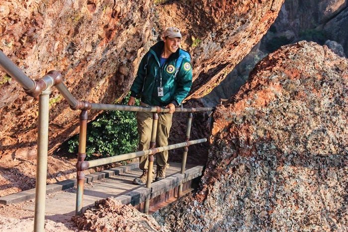Pinnacles-ranger-HighPeaksBridge_NPSInstagram_700 A park volunteer hiking the High Peaks bridge, in the light of the sunrise