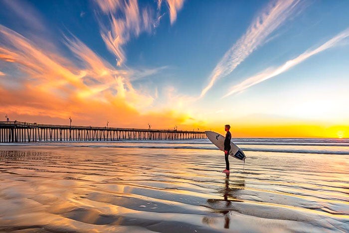 Surfer near the pier in Pismo Beach