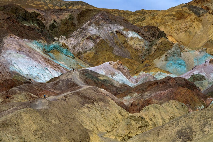 DeathValley-ArtistsPalette-Hikers_TamSteveGreenwood_700 Hikers among the colorful Artist's Palette rock formations in Death Valley National Park