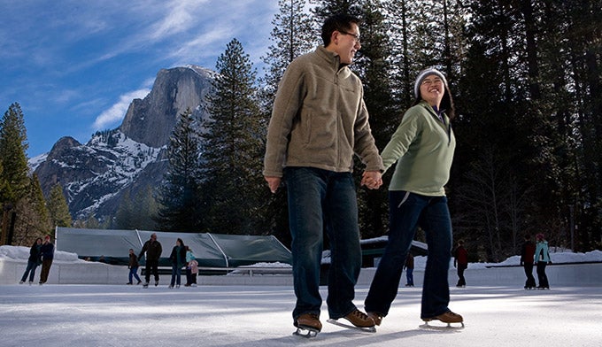 YT-CurryVillageIceRink-CoupleSkating_courtesyDNC_680 Couple skating at Yosemite's Curry Village Ice Skating Rink.