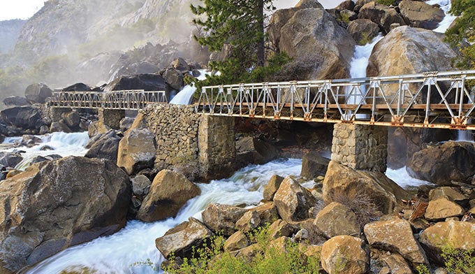 YT-WapamaFalls_shutterstock_680 Footbridge past Wapama Falls in northwest Yosemite.