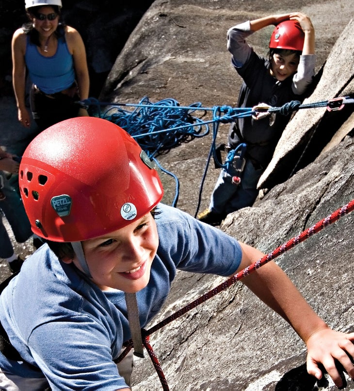 Boy learning to rock climb with the Yosemite Mountaineering School