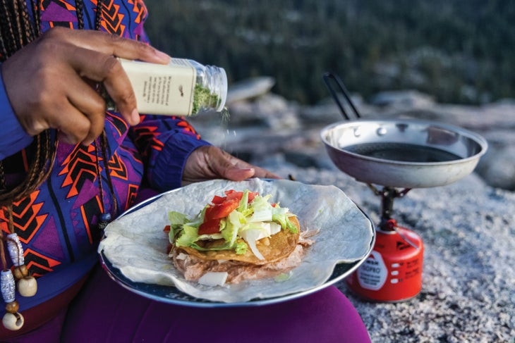 Kena Peay cooking Buffalo Chicken Crunch Wraps in Yosemite