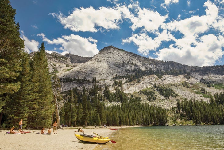 Swimming and paddling on Tenaya Lake off Tioga Road in Yosemite