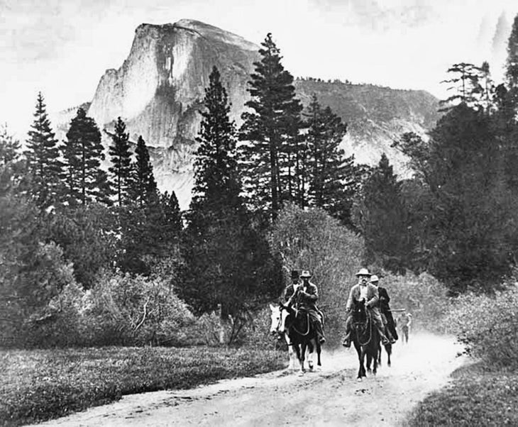 John Muir (front left) and President Theodore Roosevelt (front right) tour Yosemite Valley with a view of Half Dome